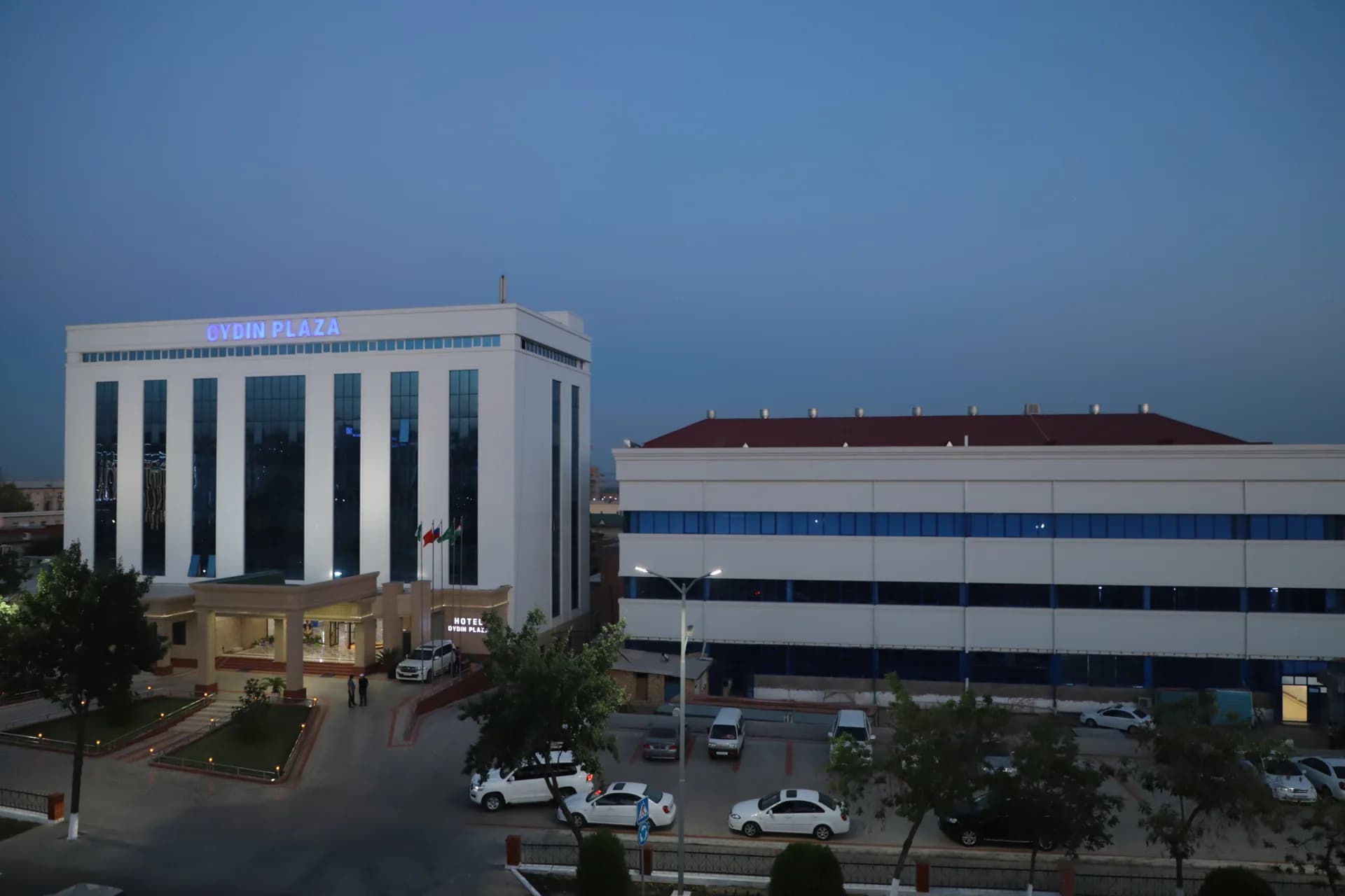 View of modern buildings and parked vehicles in city