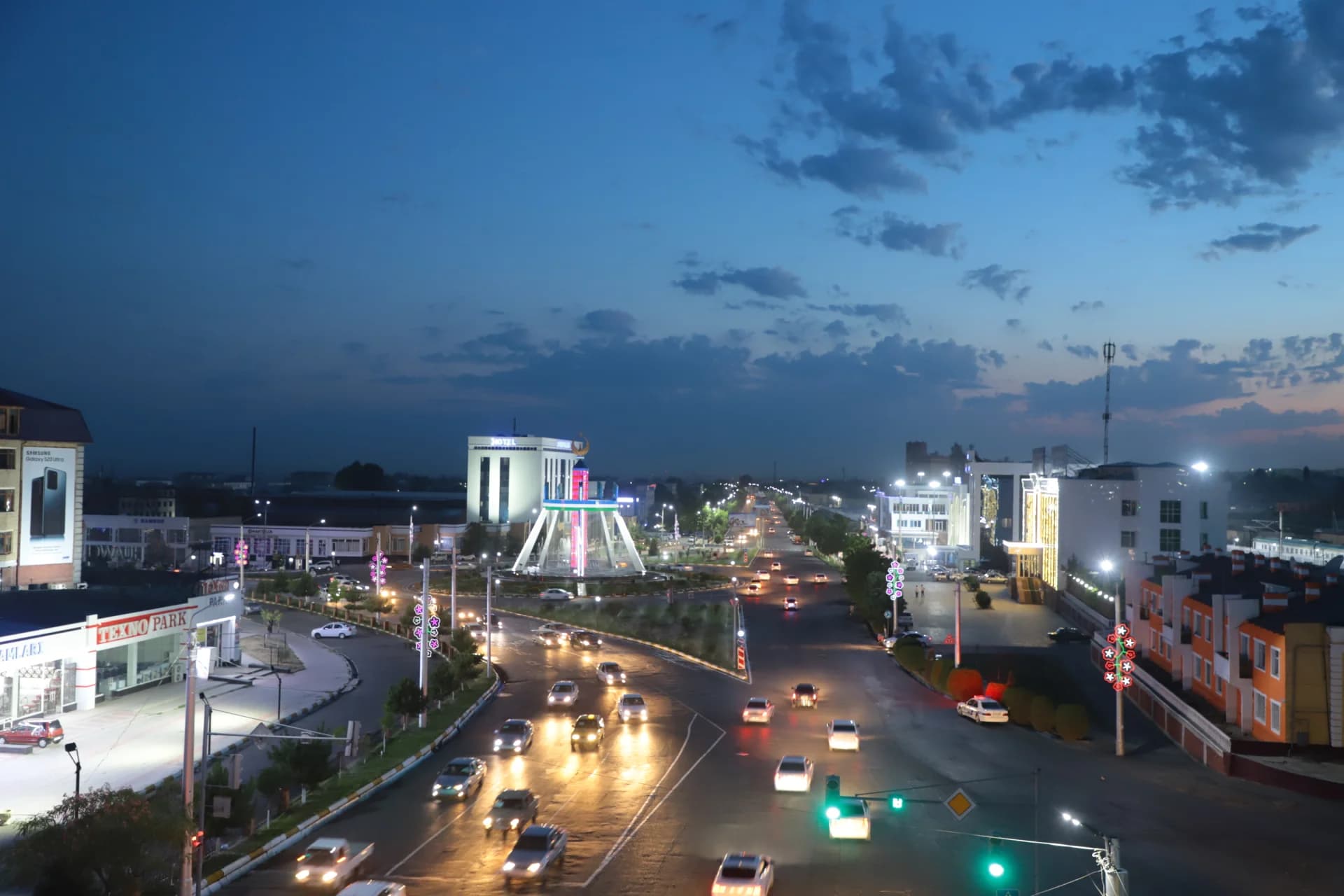 City street view with moving cars at dusk