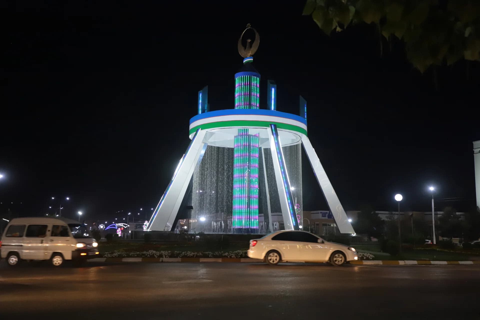 Illuminated monument and fountain at night