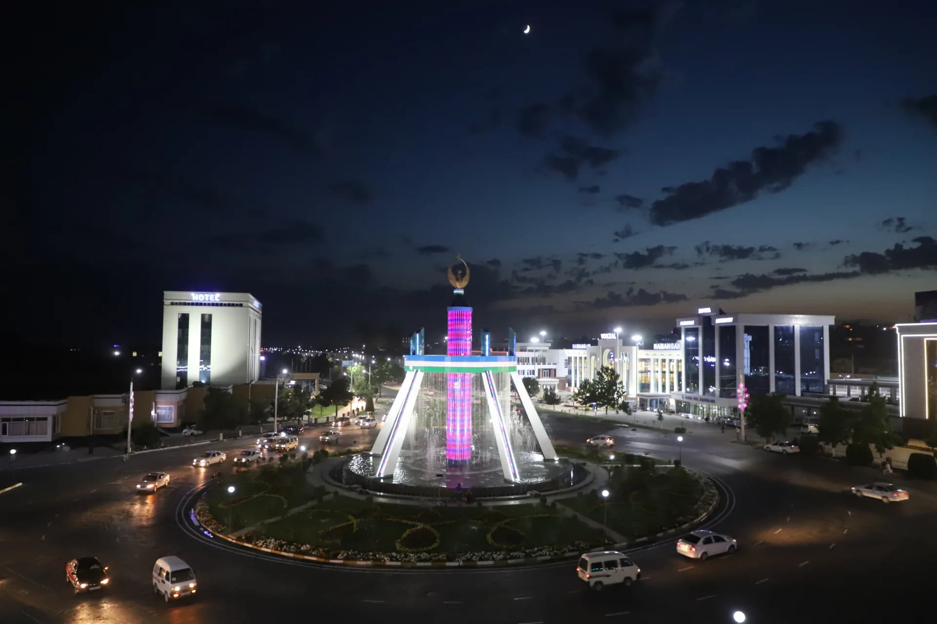 Illuminated city square and fountain at night