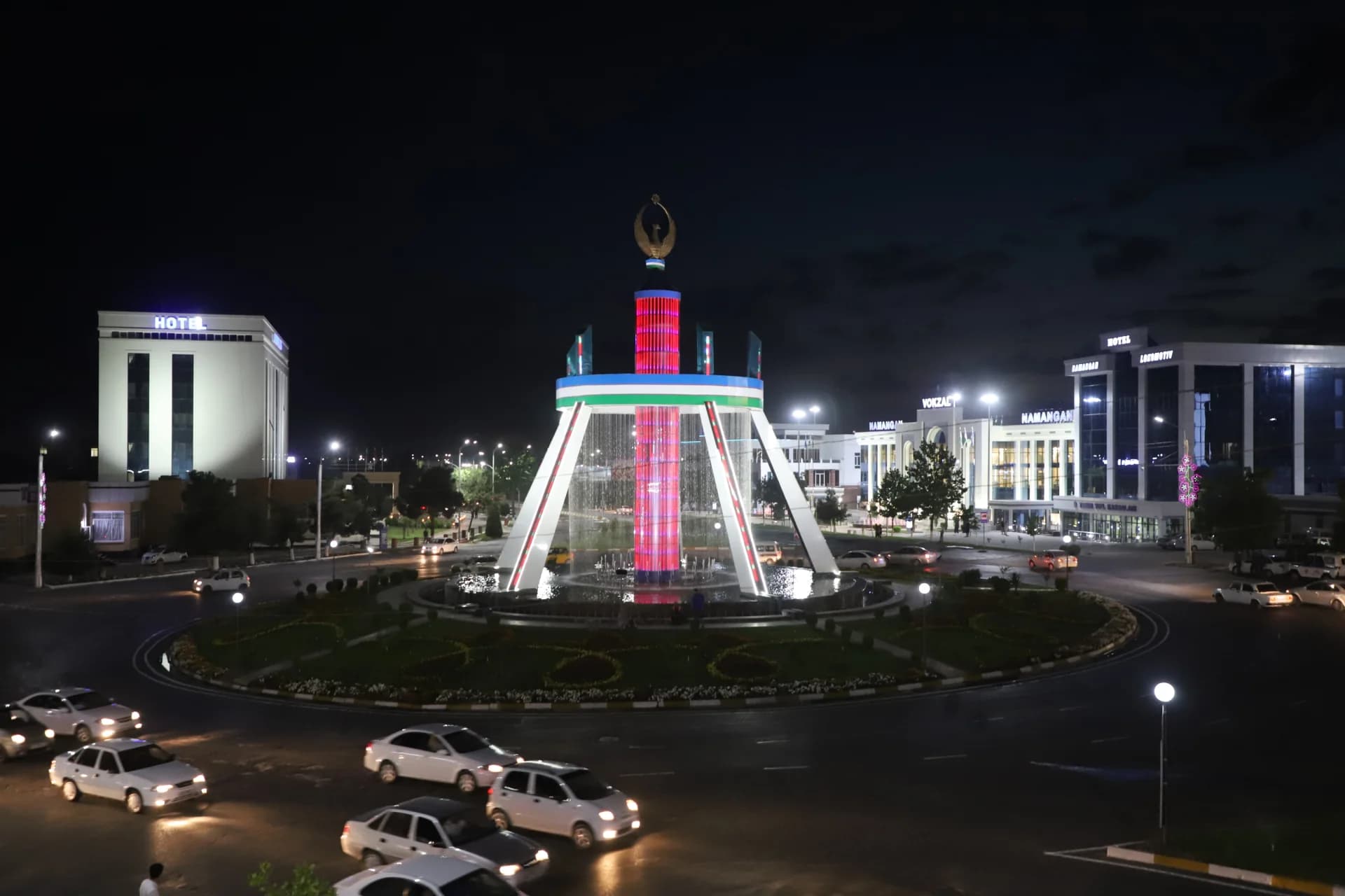 Illuminated city square and fountain at night