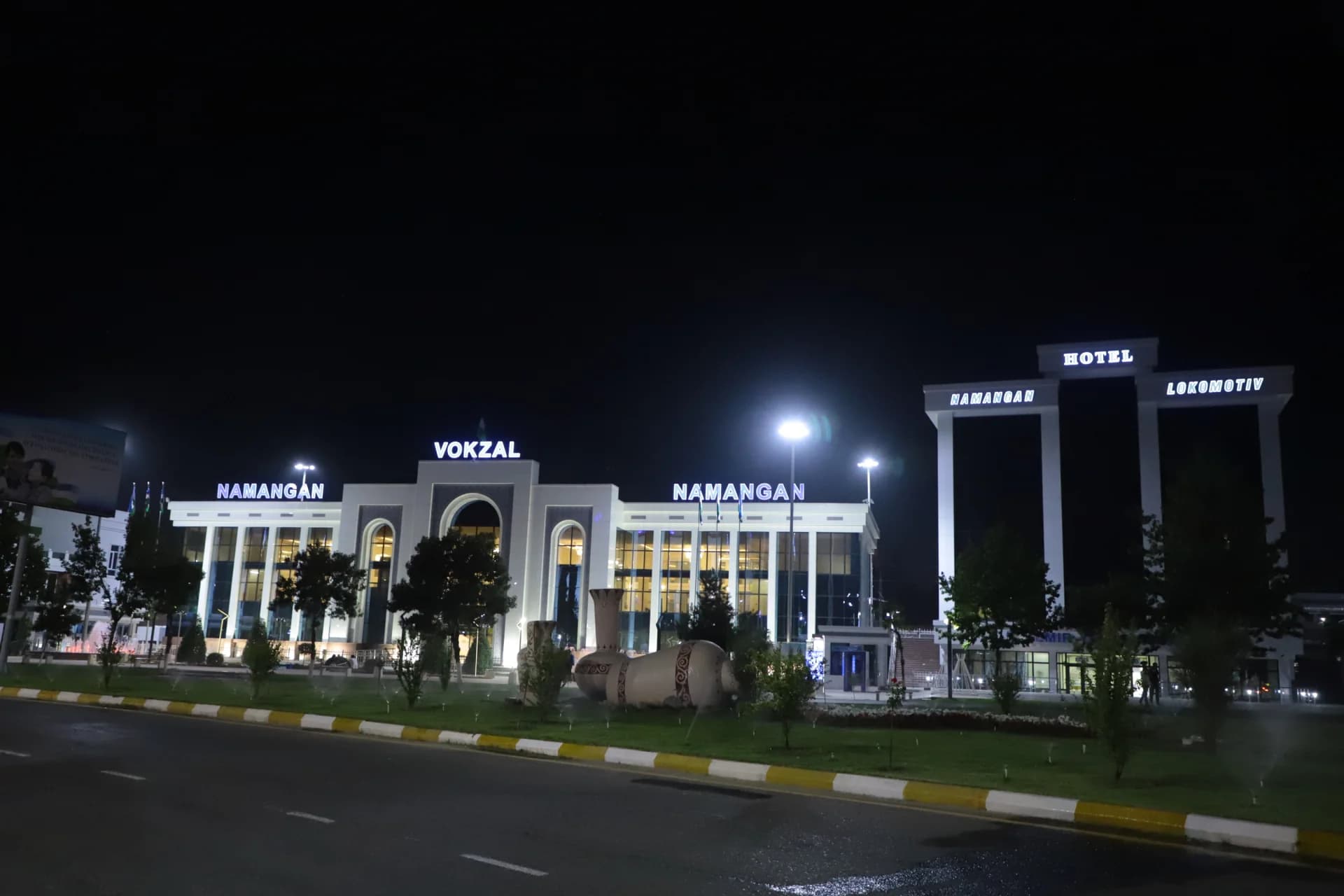 Illuminated station building and hotel at night