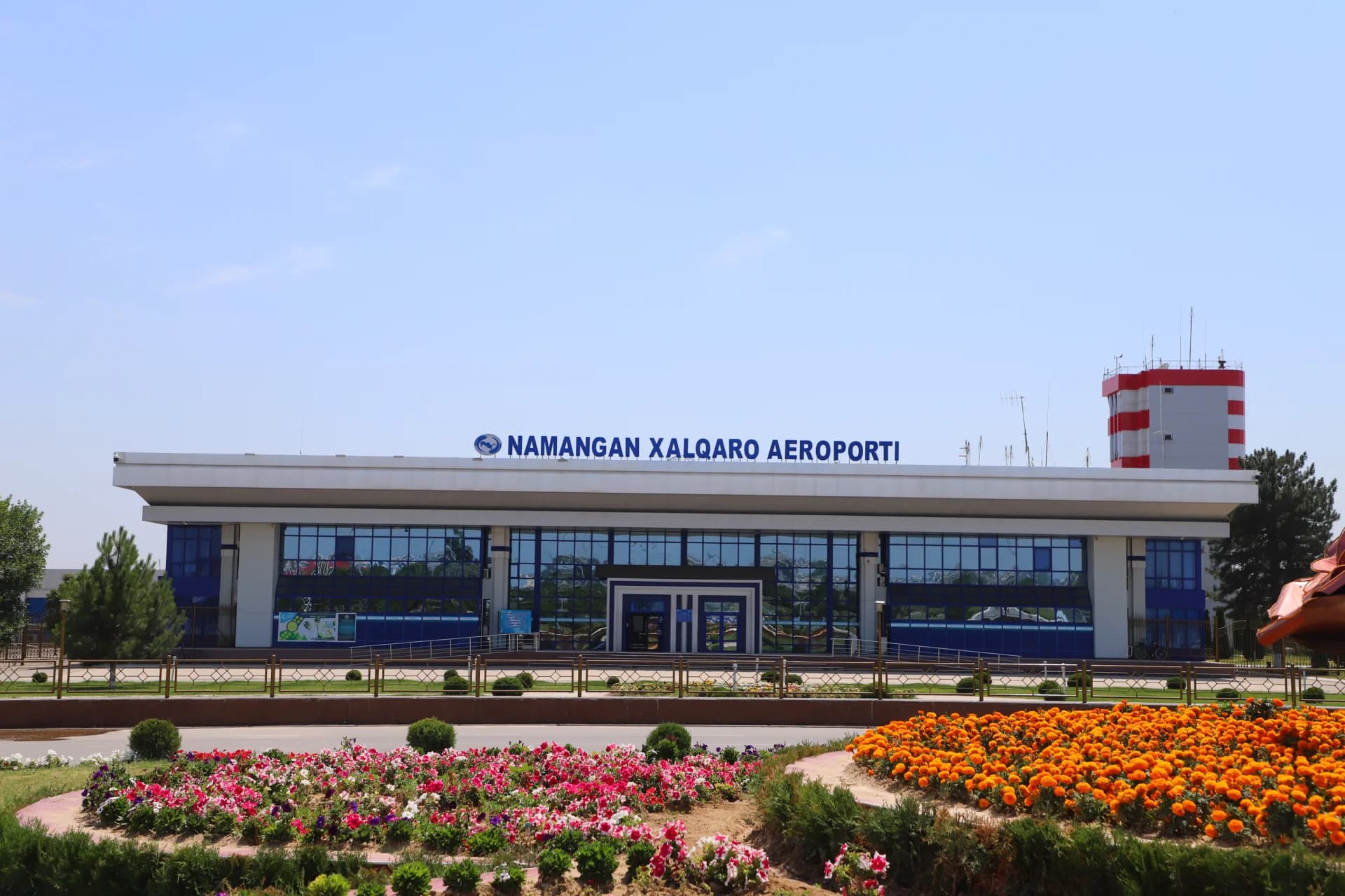 Modern airport building exterior with blue glass facade