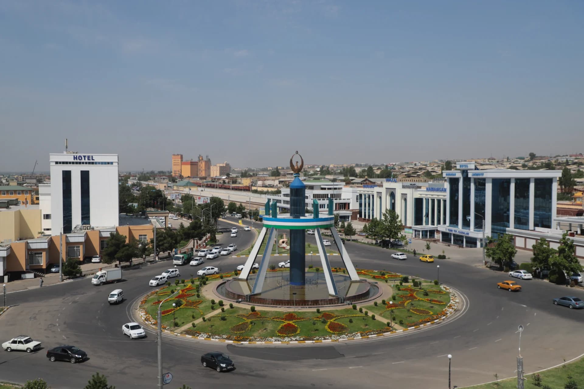 City square with fountain and surrounding traffic