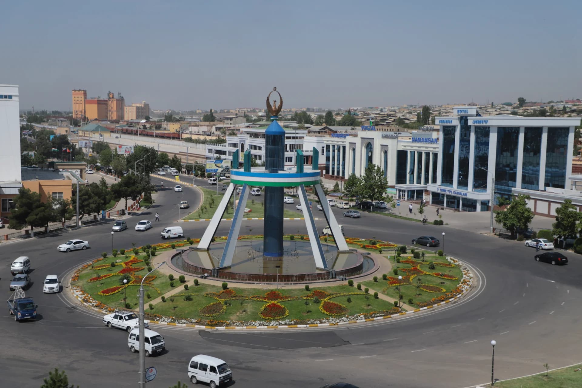 Elevated view of a large city traffic roundabout with a decorative monument