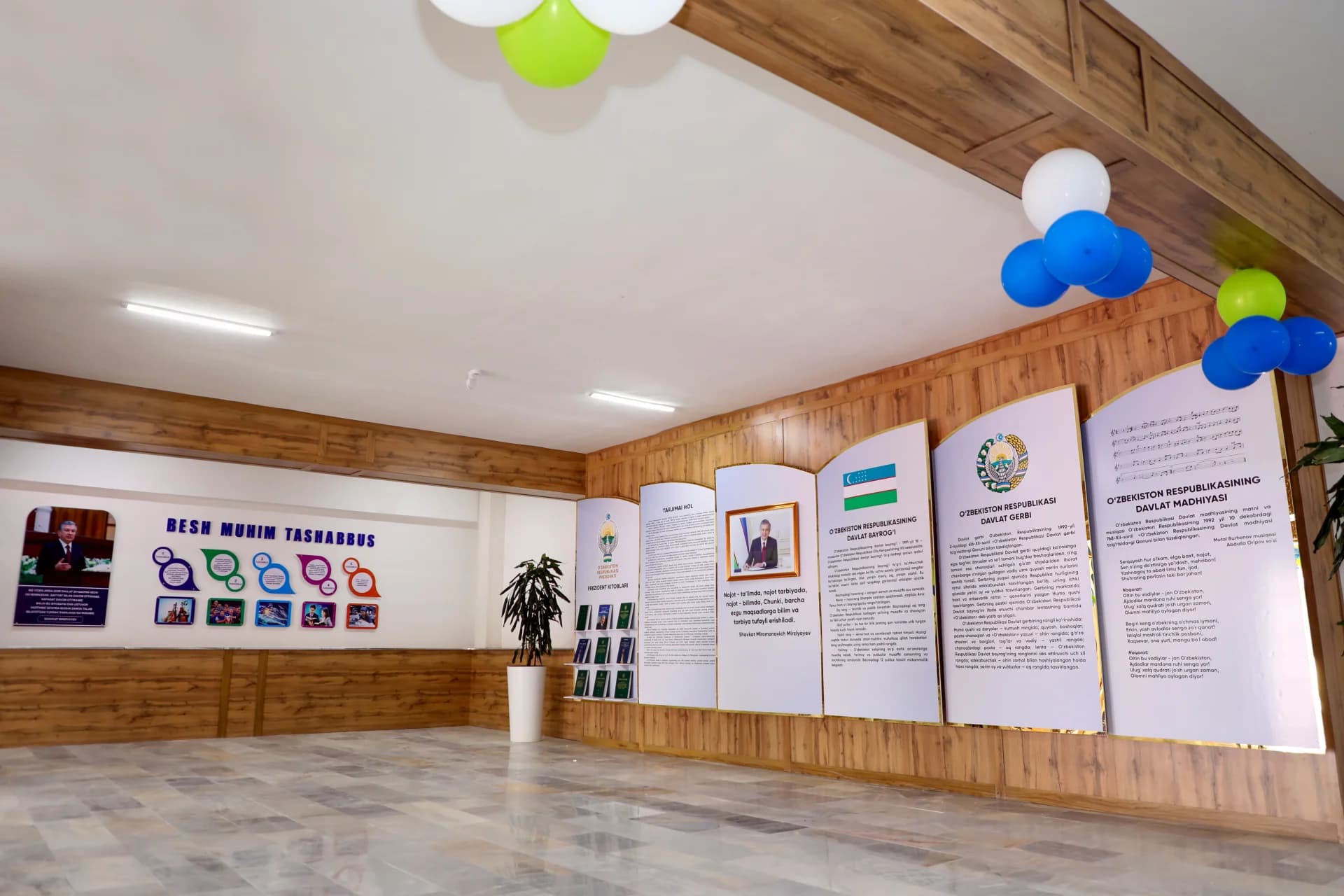 Interior exhibit panels with text and portraits mounted on a wooden wall