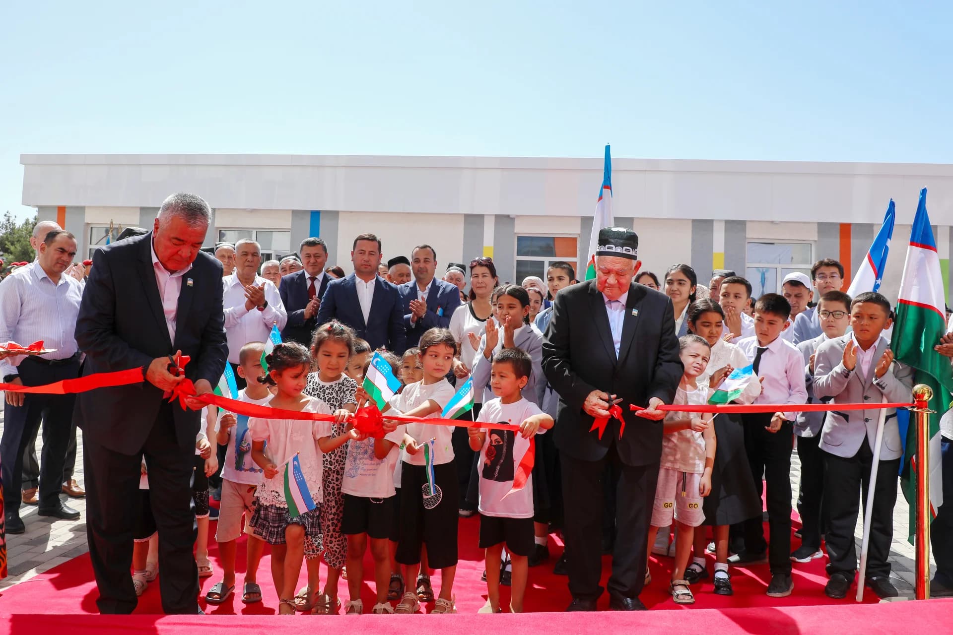 People cutting ribbon at opening ceremony