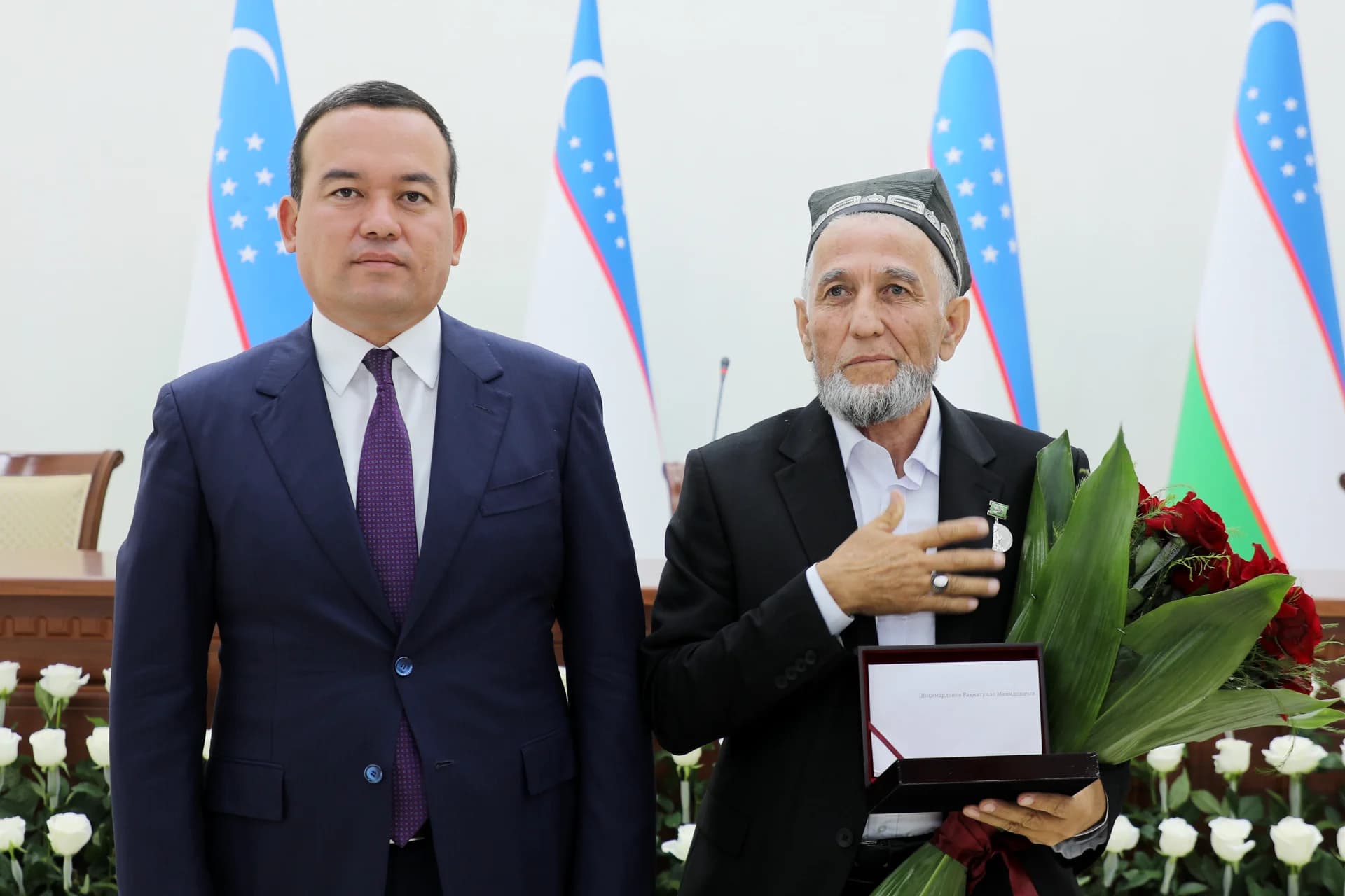 Men standing together indoors with flags