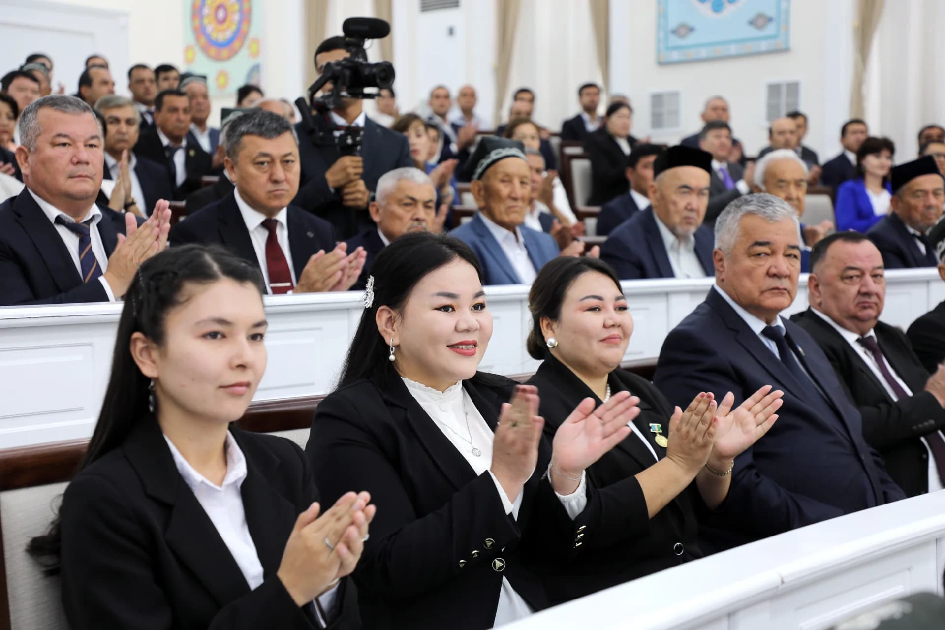 People clapping in a conference hall