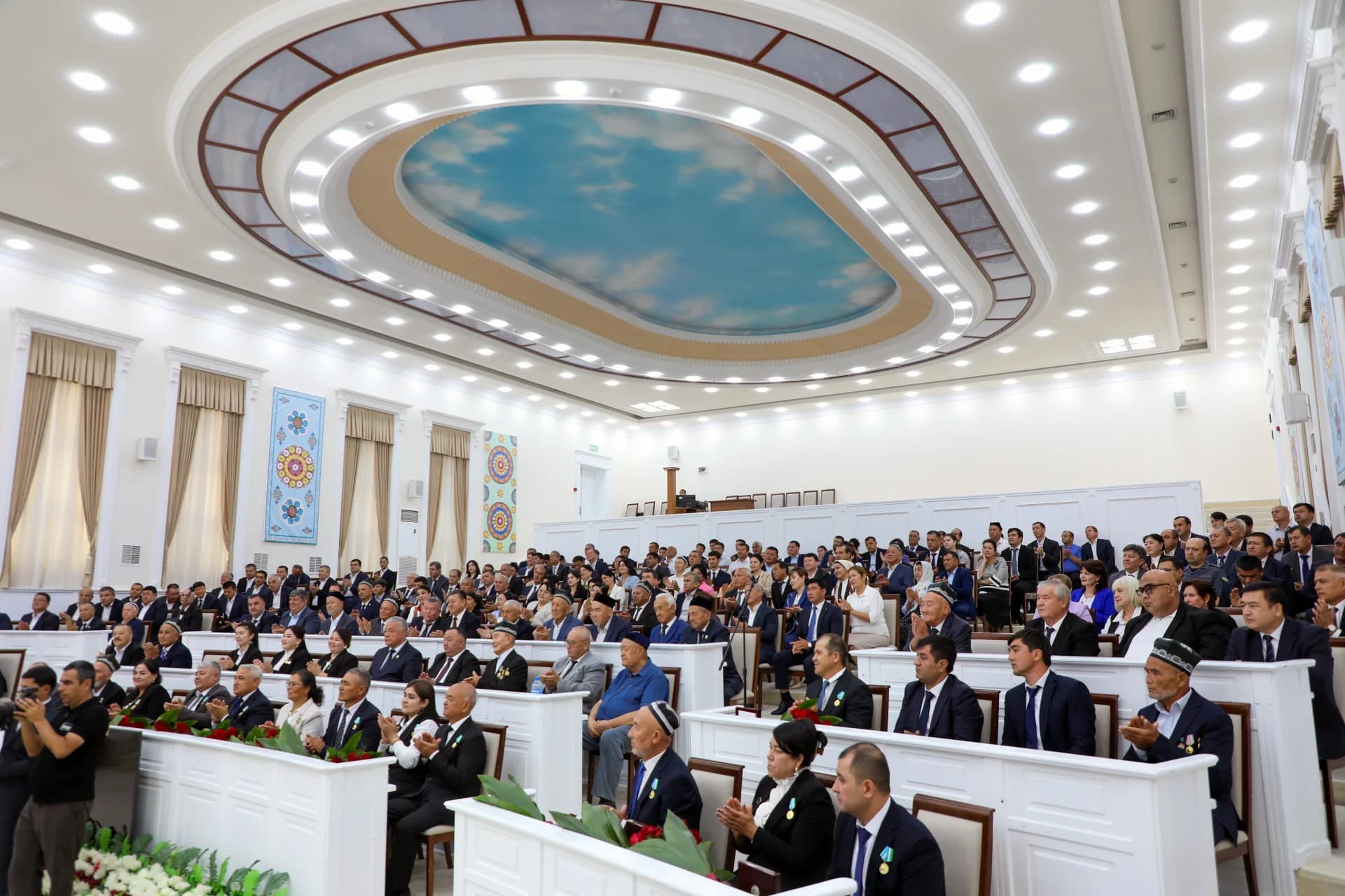 Group of people seated in a large assembly hall