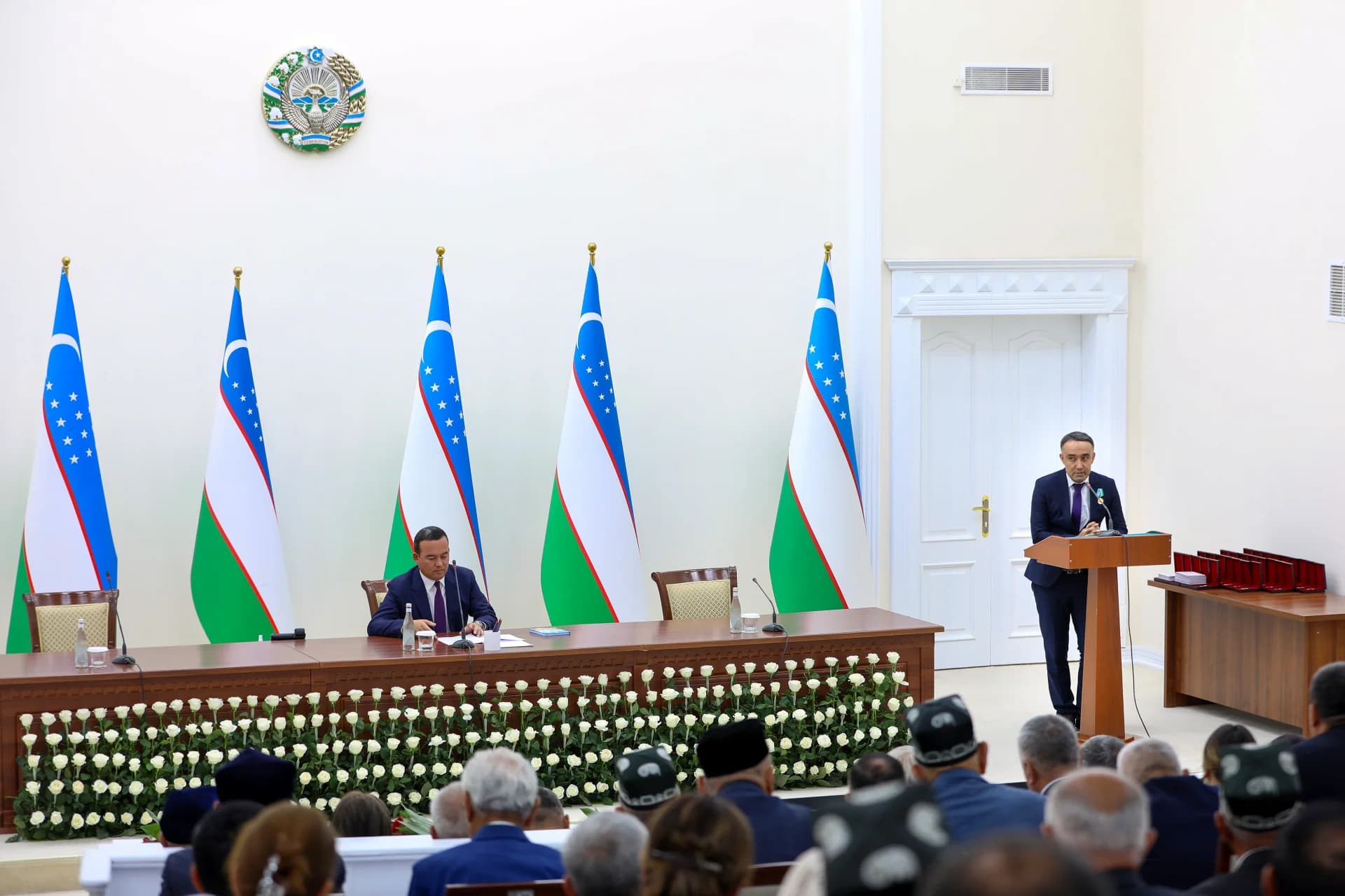People attending a formal meeting in a conference hall