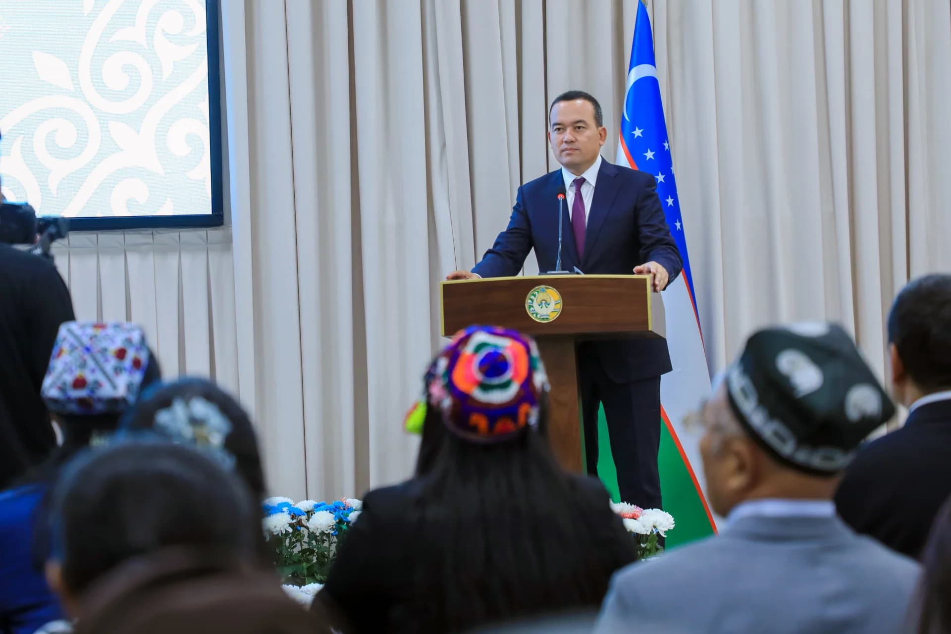 Man speaking at a podium before an audience