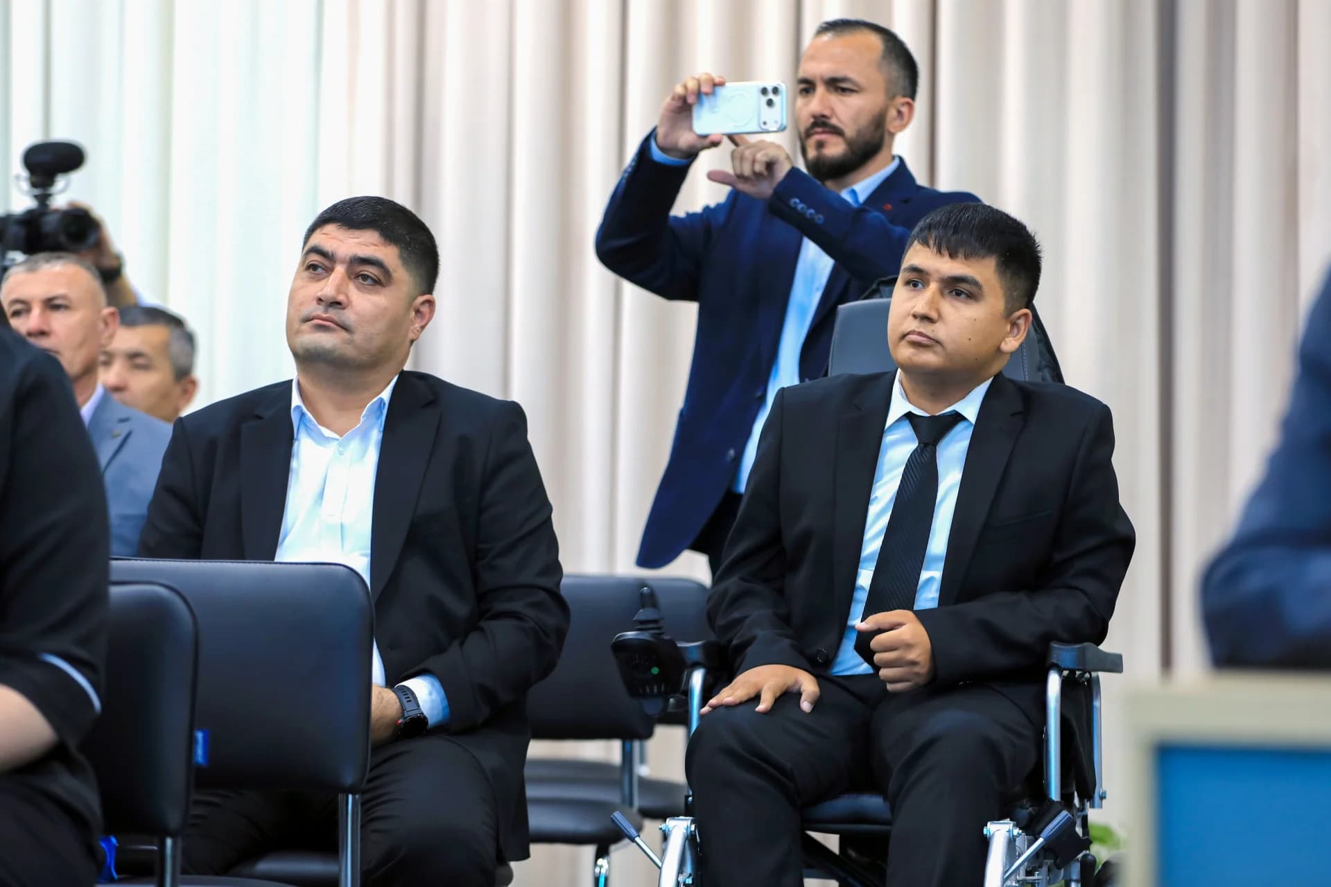 People seated indoors at a gathering