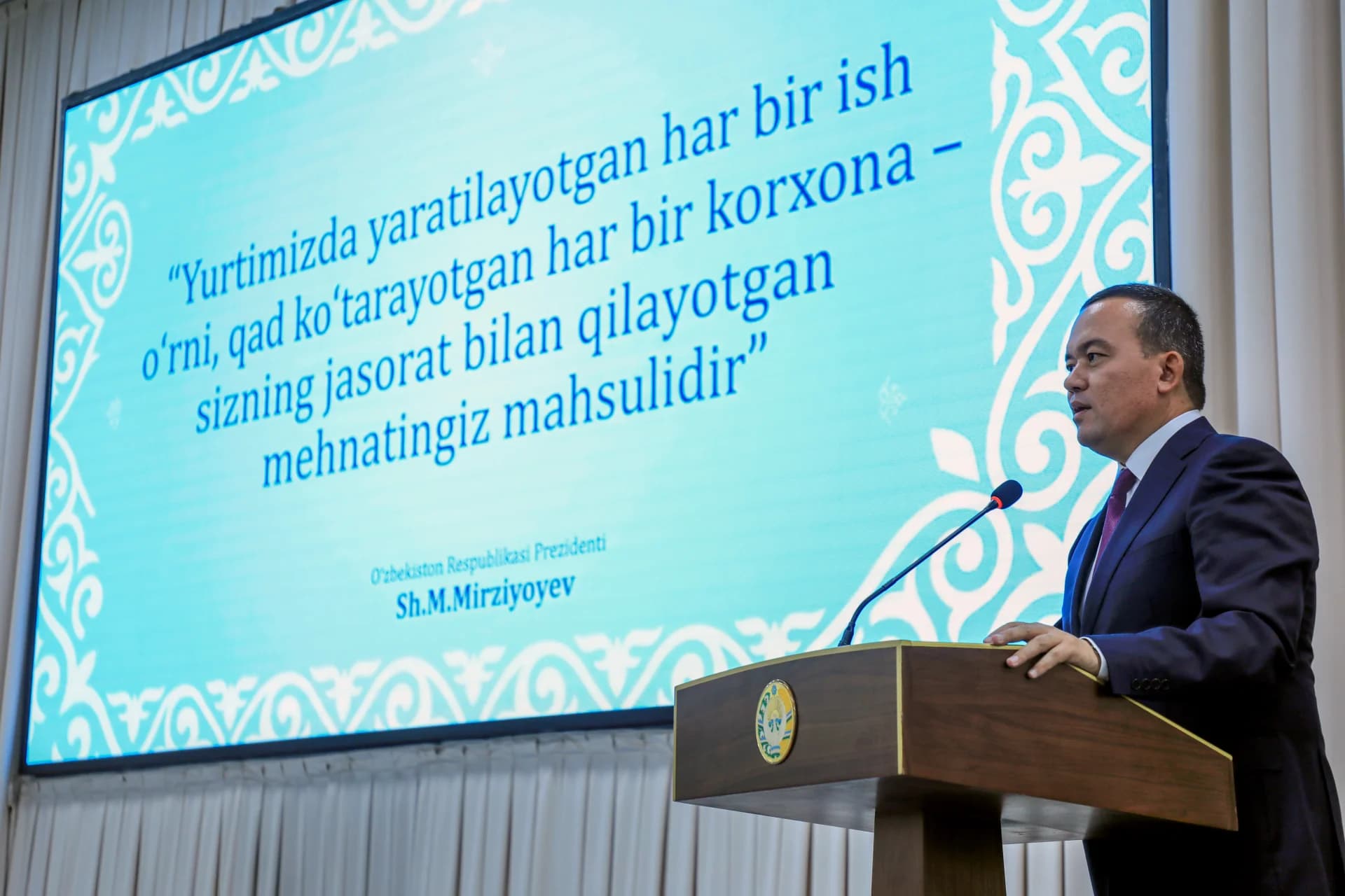 Man speaking at podium during public address