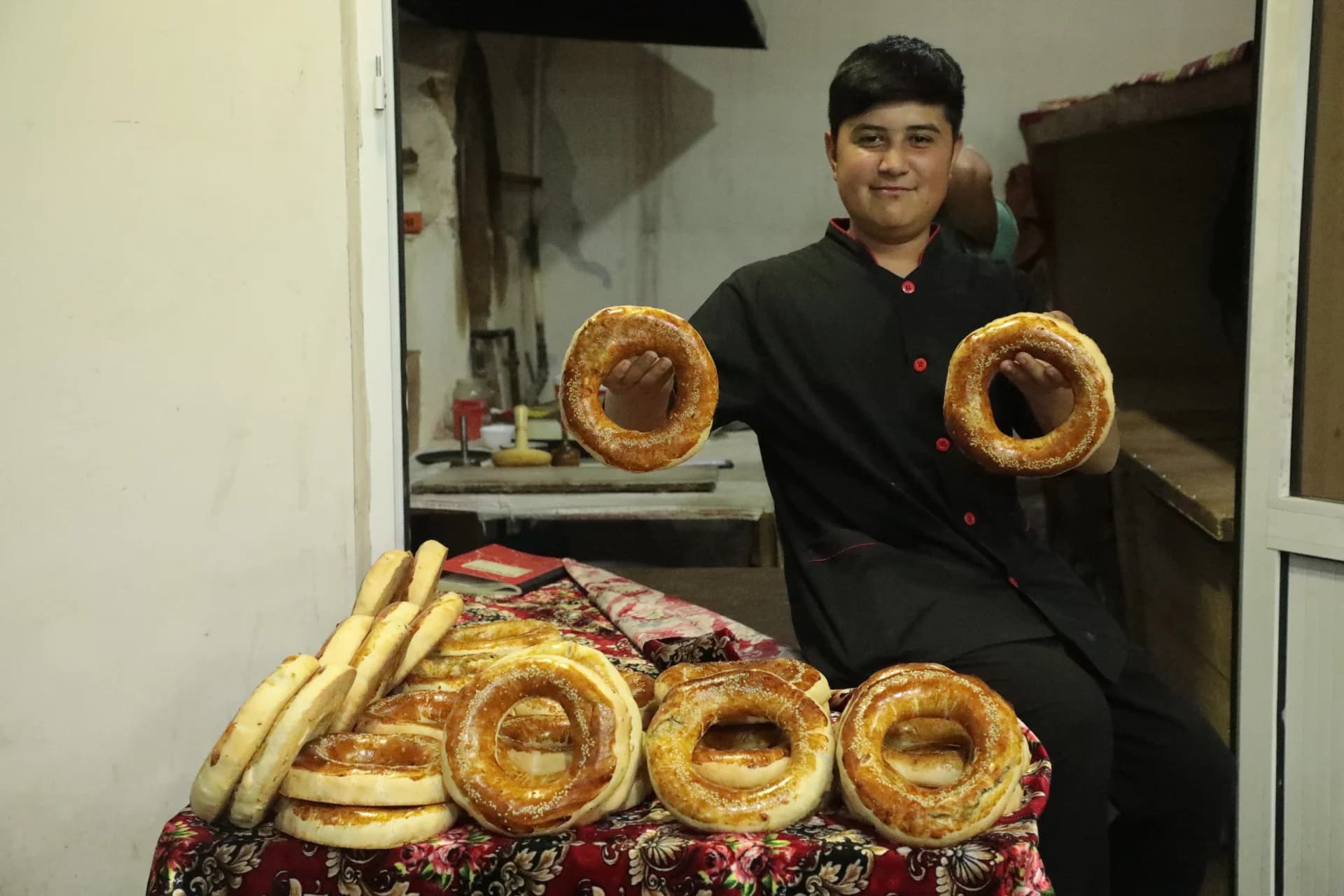Person holding freshly baked round flatbreads