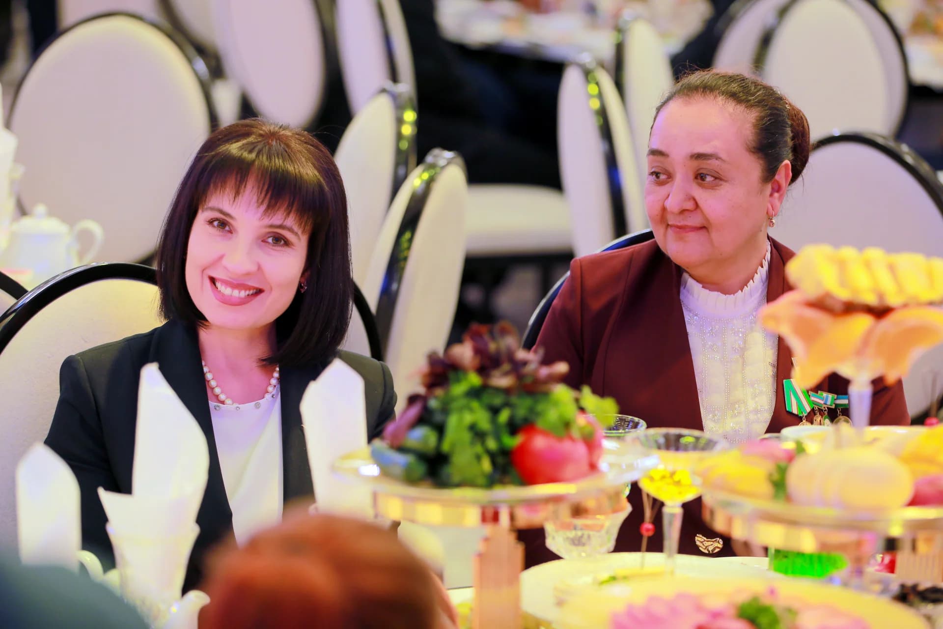 People seated at a table during an indoor gathering