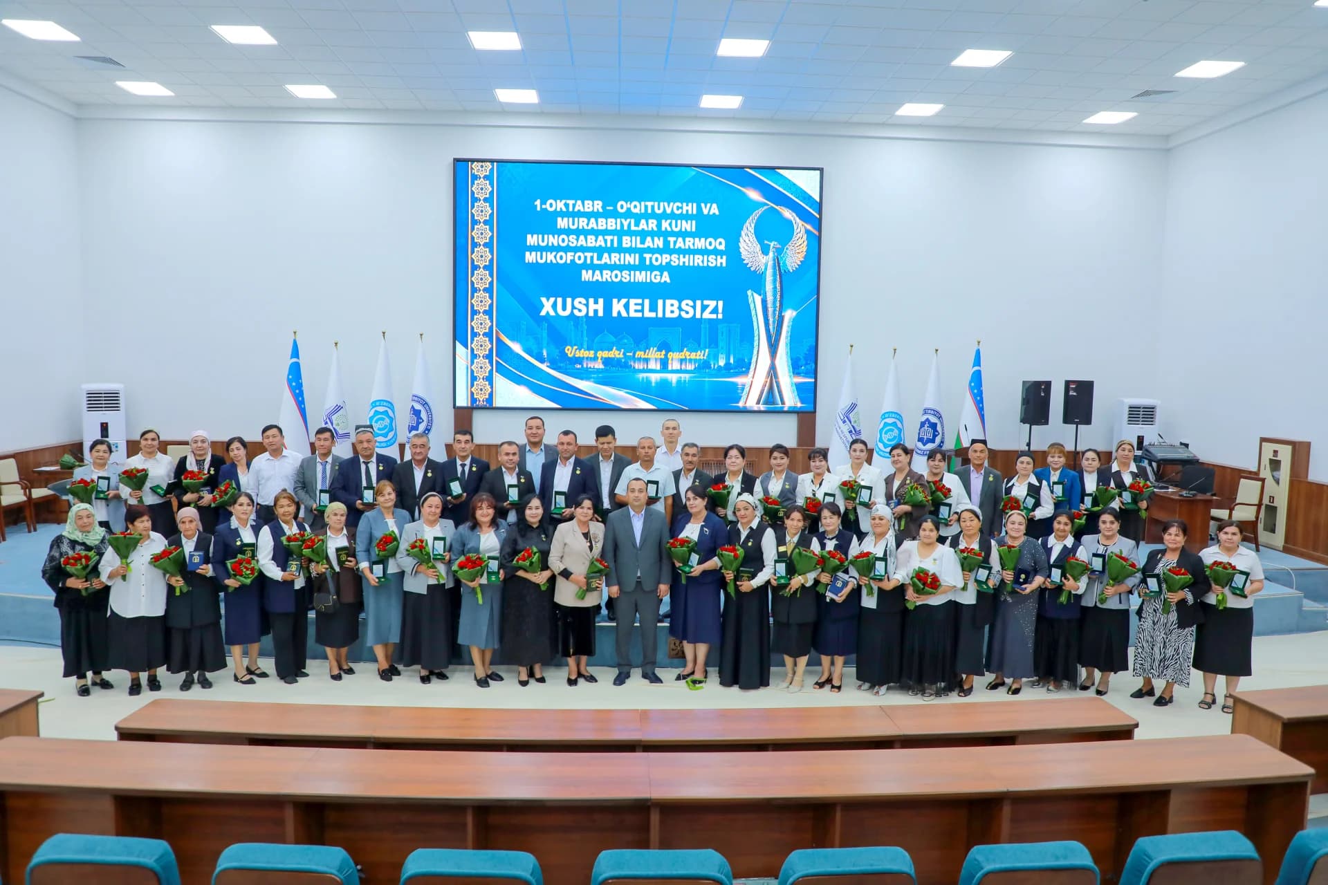 Group portrait of people in an indoor auditorium