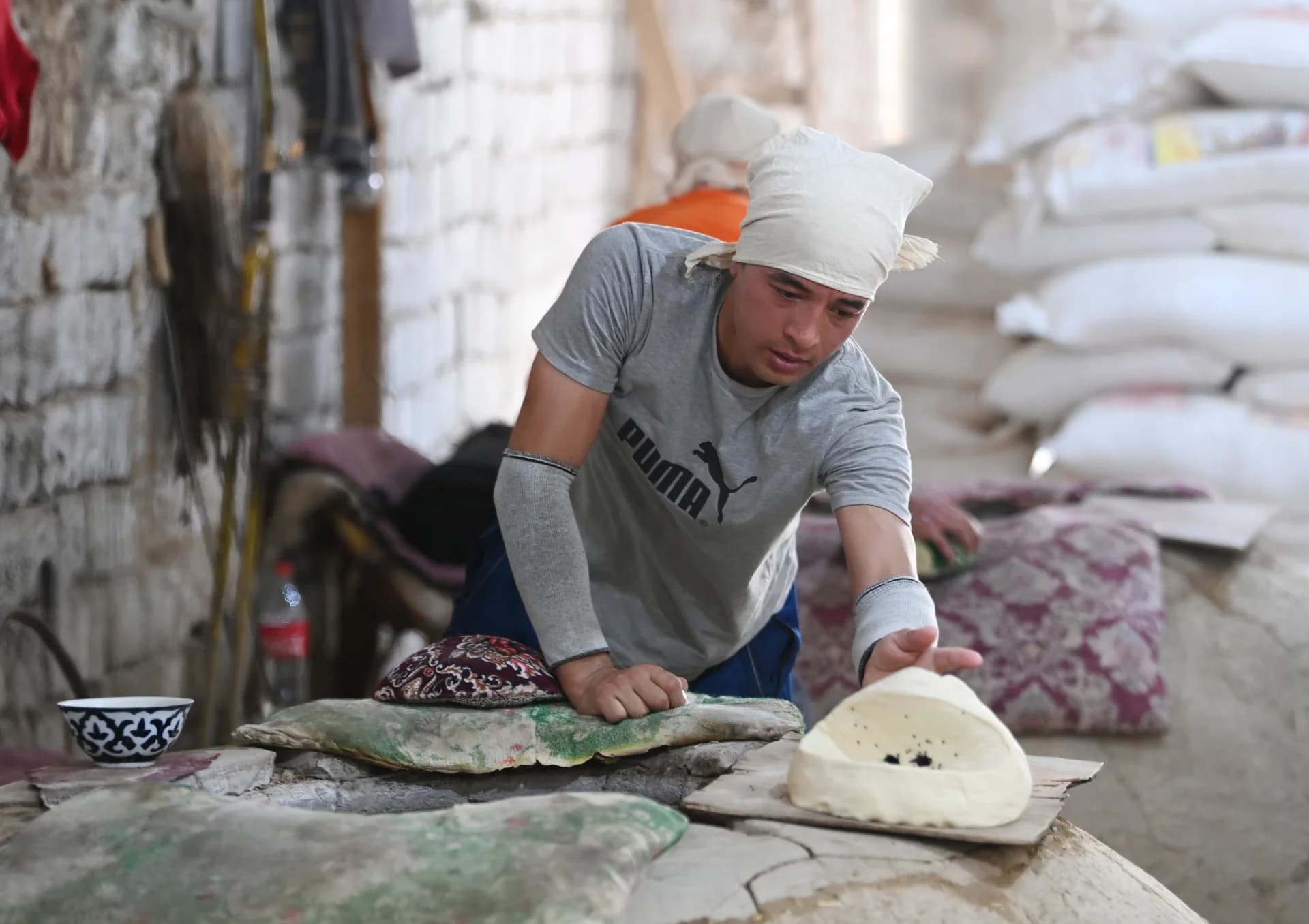 Person preparing bread inside a bakery