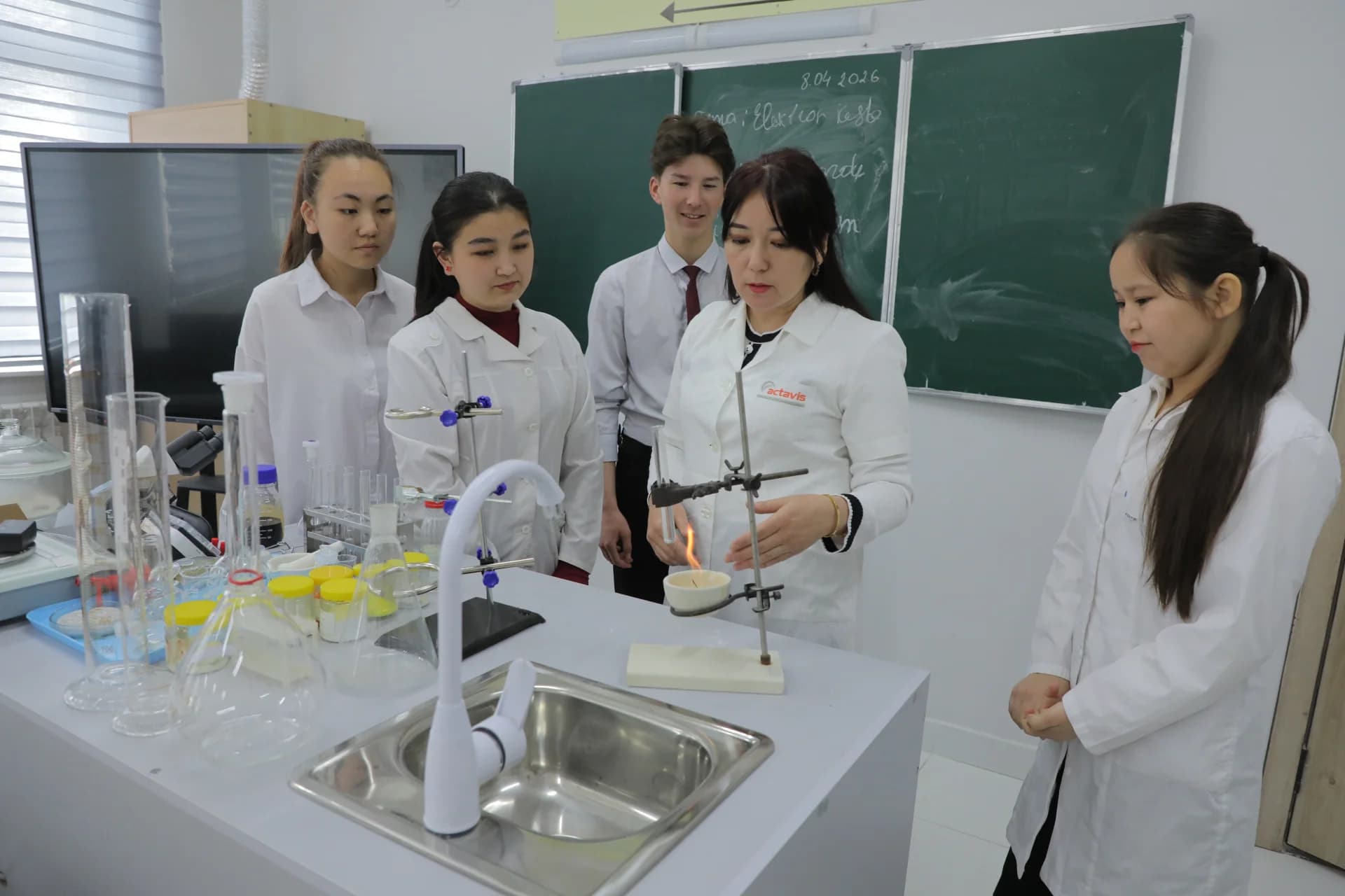 Students and teacher conducting a science experiment in a classroom