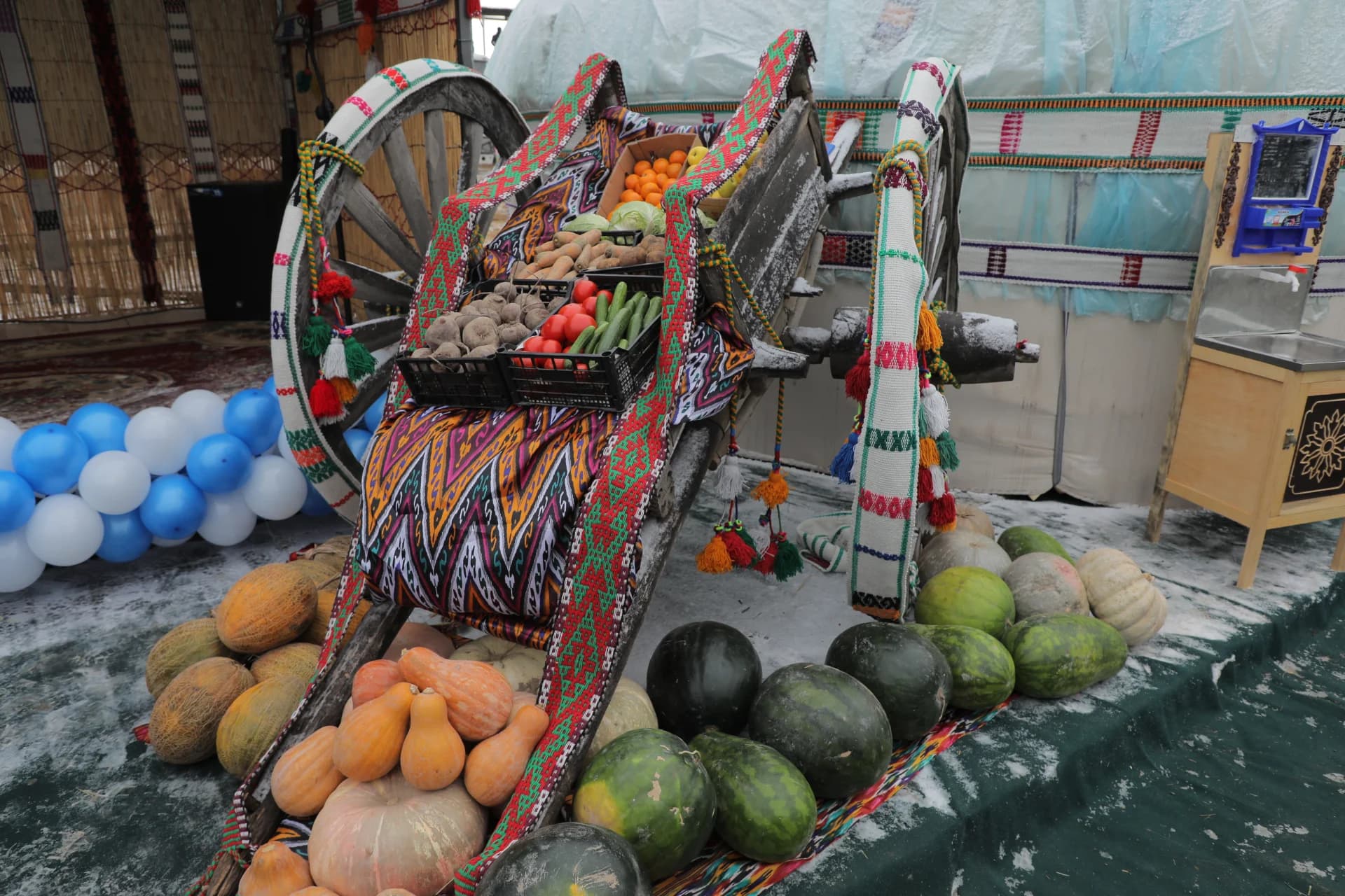 Traditional wooden cart loaded with fresh produce and watermelons outdoors