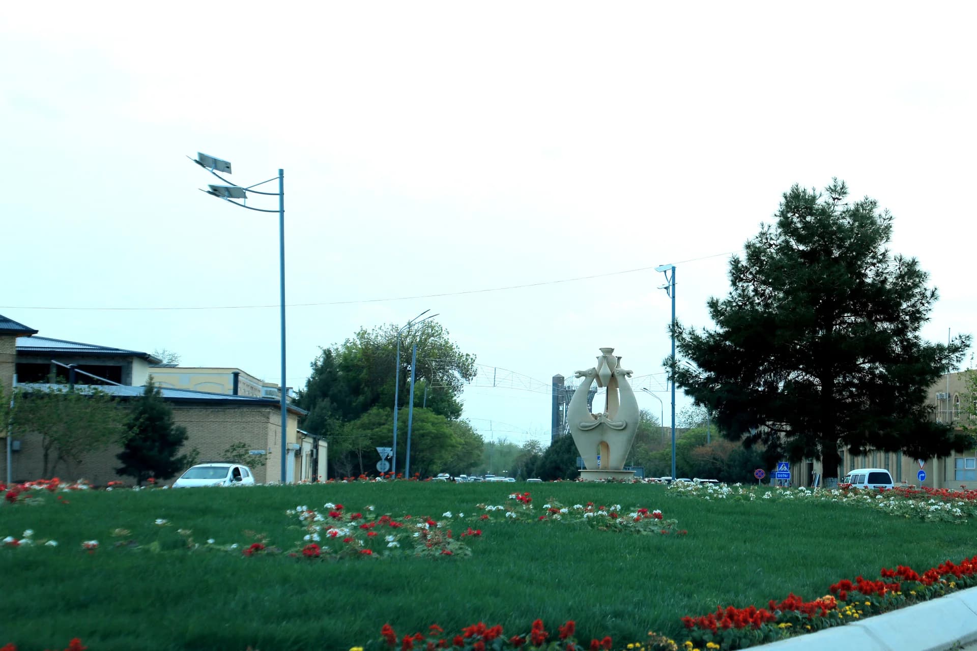 City street scene with landscaped roundabout and monument