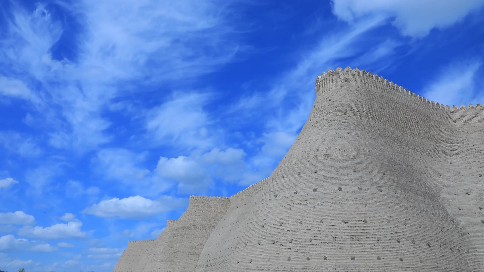 Ancient fortress walls under a bright blue sky