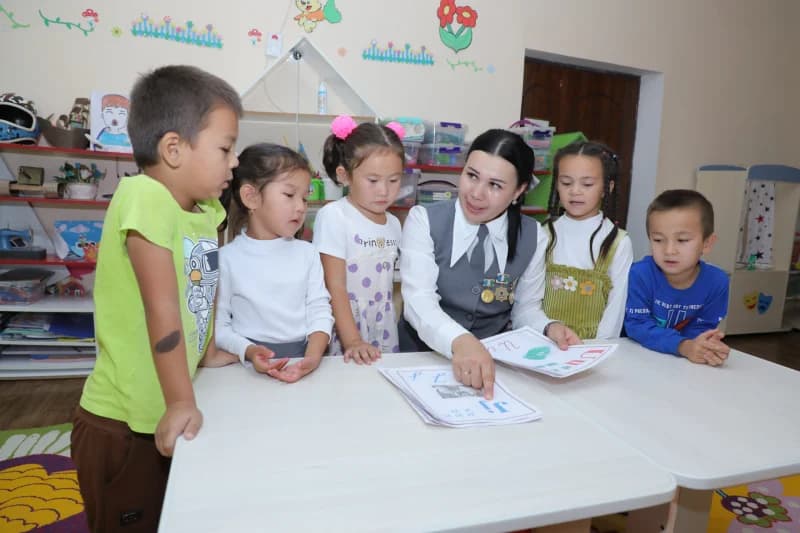 Teacher instructs children in classroom