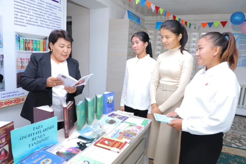Librarian showing books to students