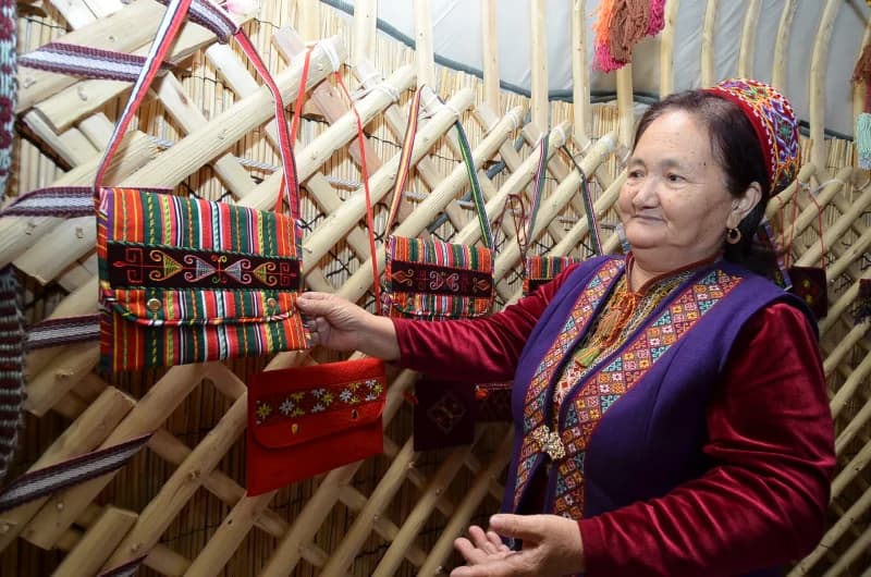 Artisan displays handmade textile bags