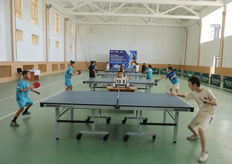 Children play table tennis match