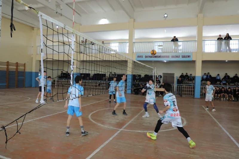 Young athletes playing indoor volleyball