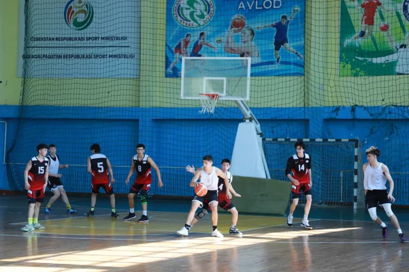 Young athletes playing basketball match