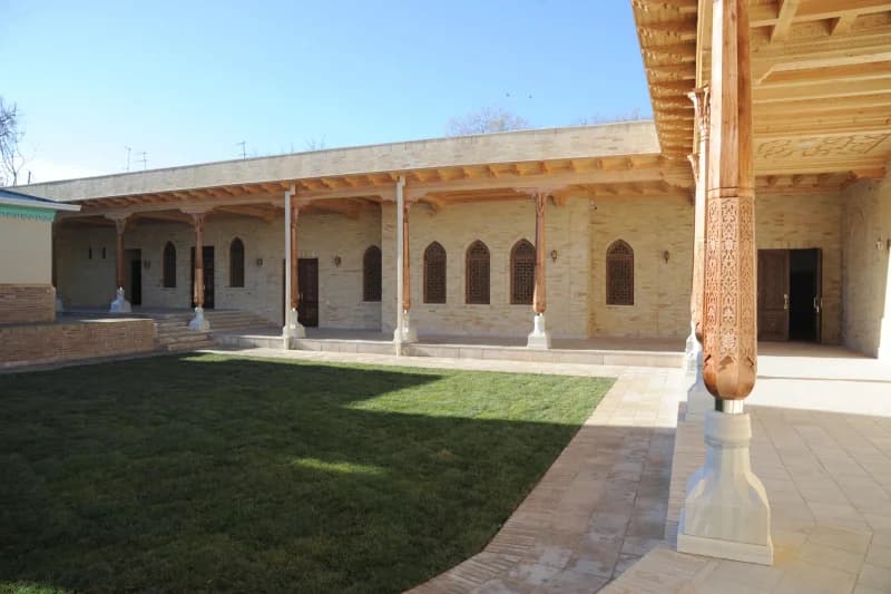 Carved wooden columns adorn courtyard