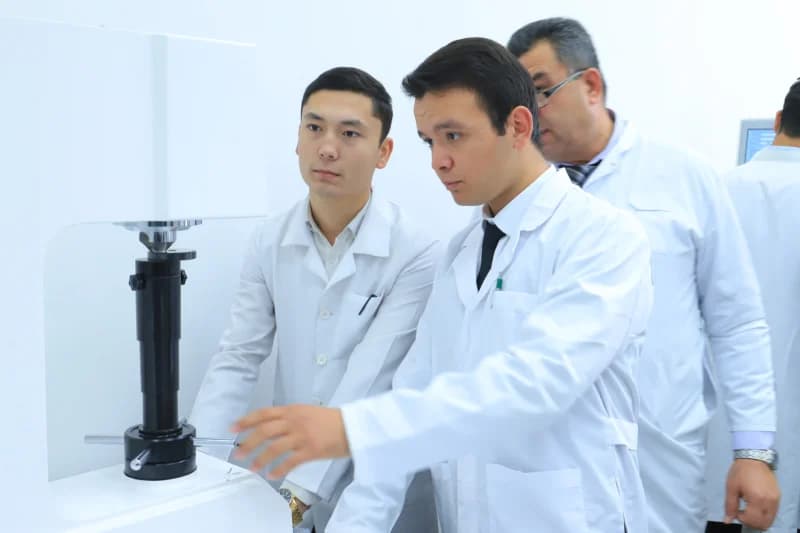 Scientists operating laboratory testing equipment