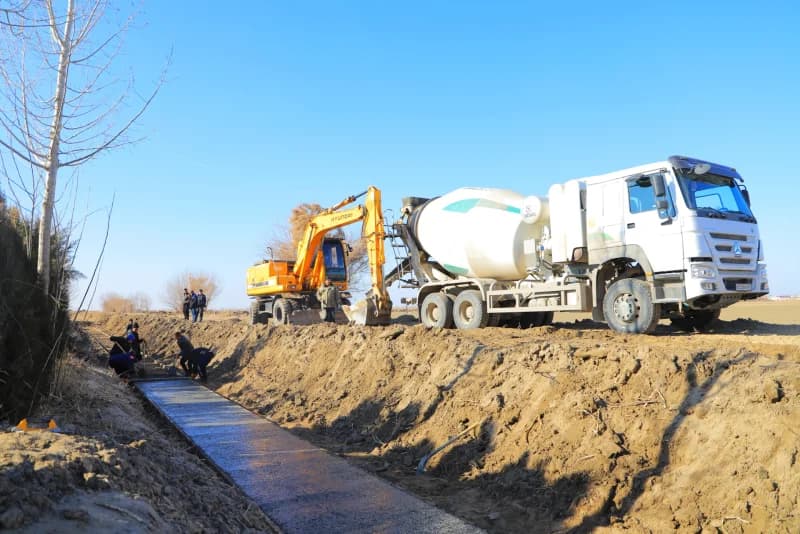 Workers pouring concrete in canal