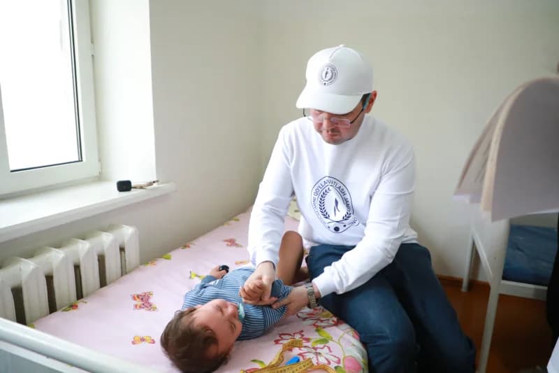 Doctor examines baby in hospital room
