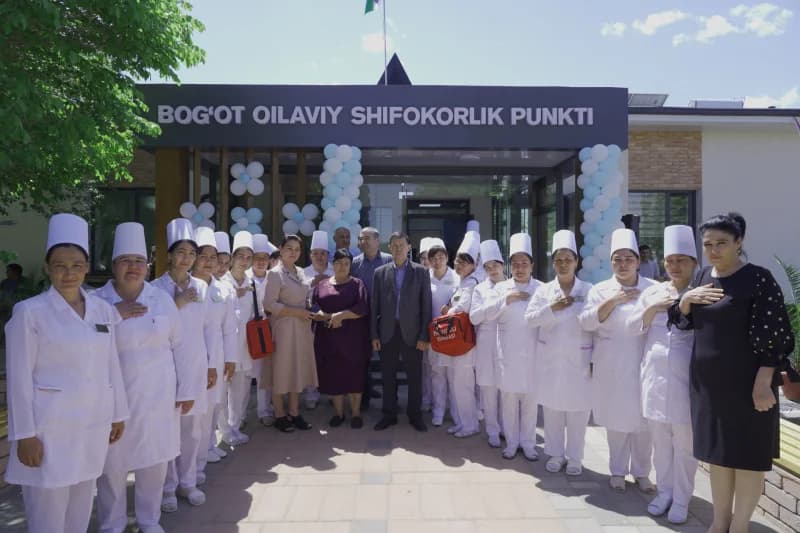 Medical staff members posing outside clinic