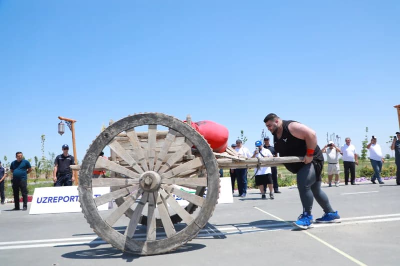 Athlete pushing heavy wooden cart