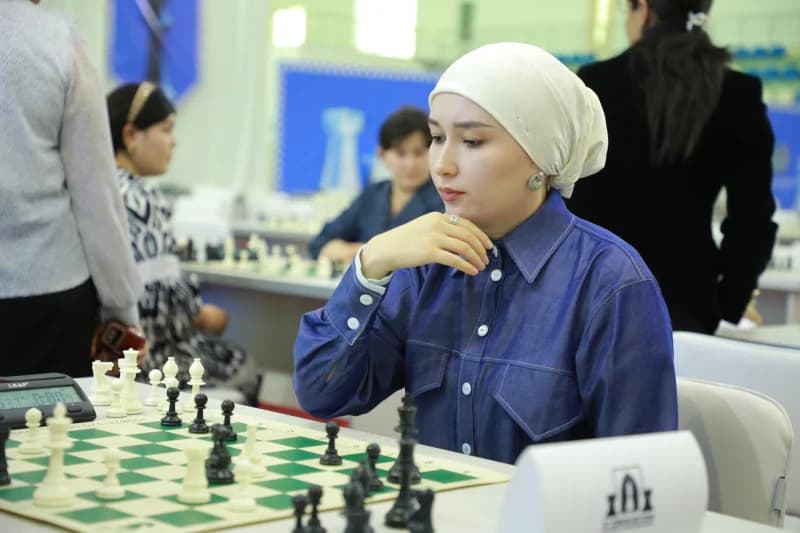 Young woman playing competitive chess