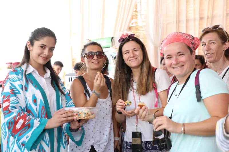 Smiling women tasting cookies together