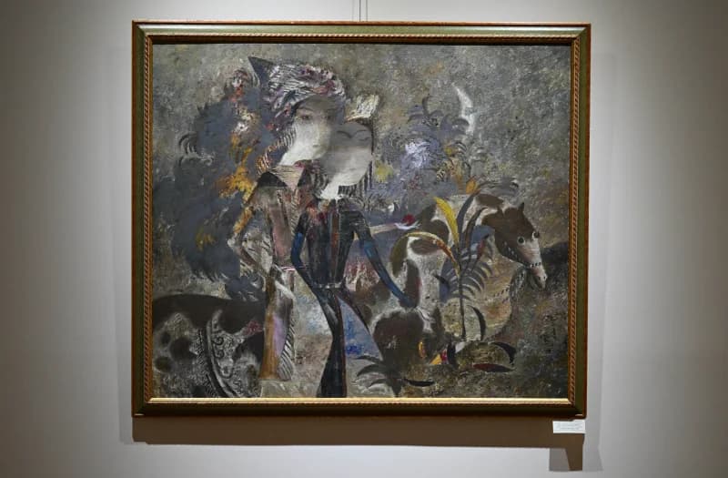 Framed artwork hangs in gallery