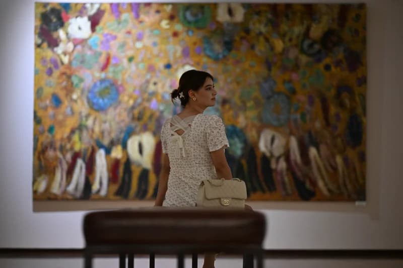 Woman viewing painting in gallery