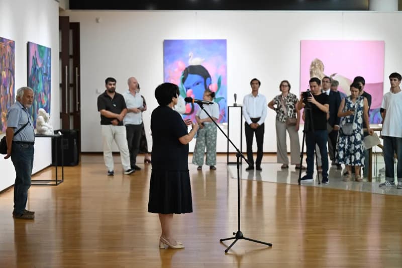 Woman speaking at art exhibition