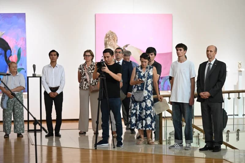 People attending art gallery exhibition