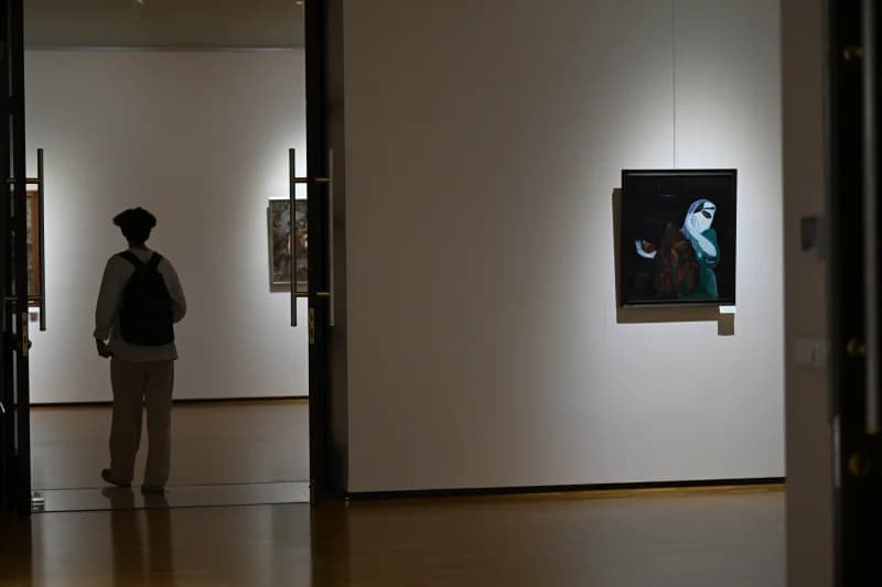 Visitor exploring modern art gallery exhibition