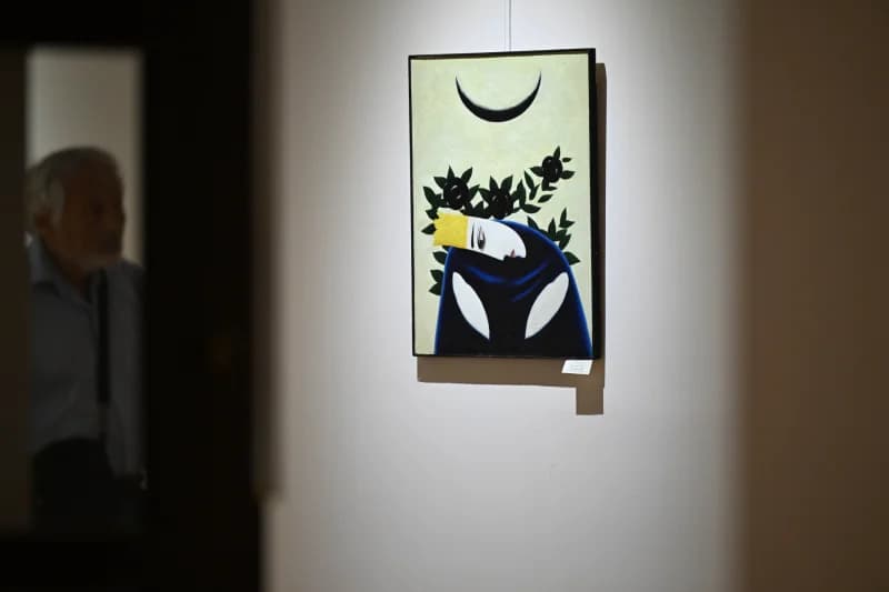 Visitor viewing painting in gallery