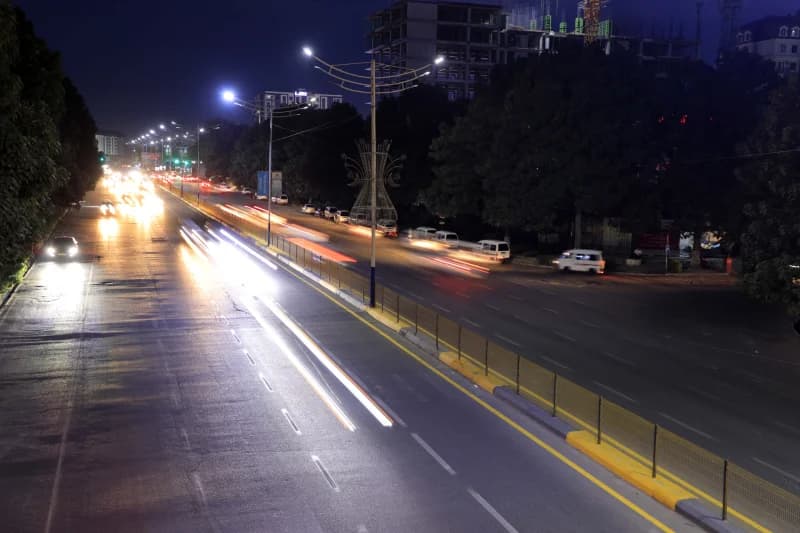 Urban traffic on a multi-lane road at night