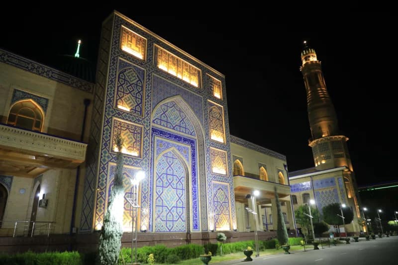 Illuminated architectural facade of a traditional building at night