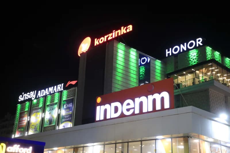 Illuminated commercial building exterior with brand signs