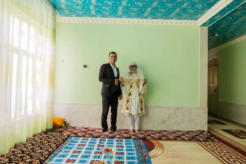 Couple posing in traditional attire indoors